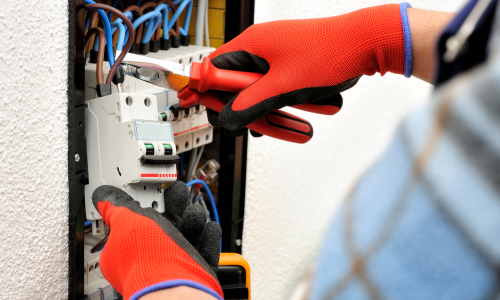An electrician installing an outlet.