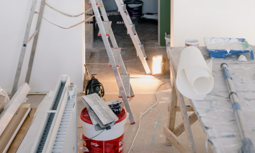 A room mid renovations with contractor supplies spread across it. 
